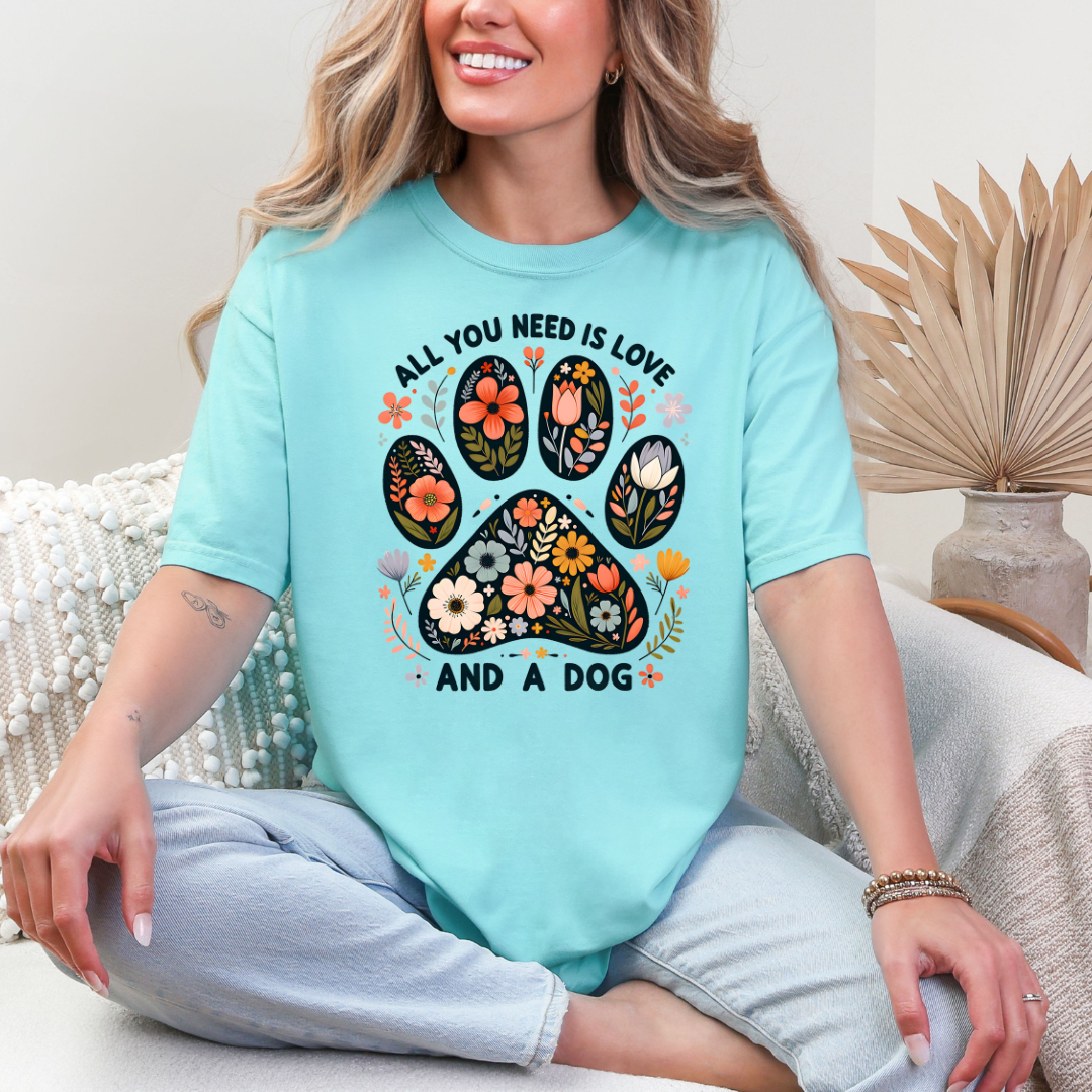 Graphic T-Shirt With Floral Paw And The Text All You Need Is Love And A Dog