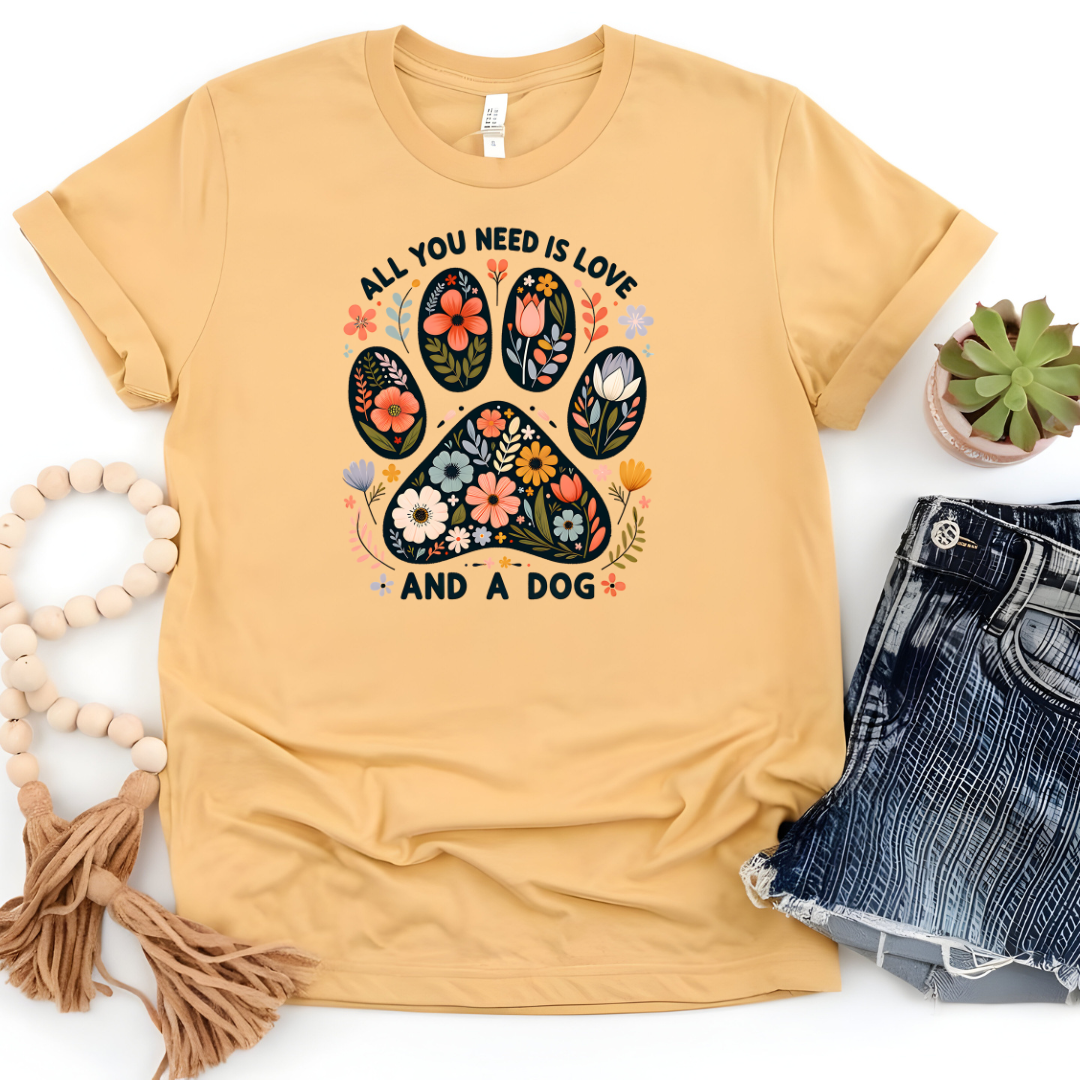 Graphic T-Shirt With Floral Paw And The Text All You Need Is Love And A Dog
