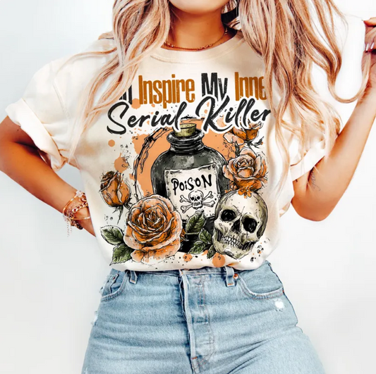 graphic t-shirt with a design featuring roses, a skull, and the text ' You Inspire My Love Serial Killer'.