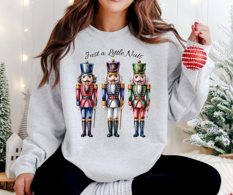 Holiday Nutcracker Design with three Nutcrackers and the Text Just a Little Nuts
