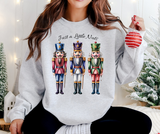 Holiday Nutcracker Design with three Nutcrackers and the Text Just a Little Nuts