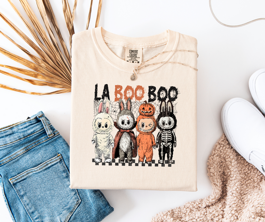 graphic t-shirt with Halloween-themed design featuring a play on words for La Boo Boo in costumes 