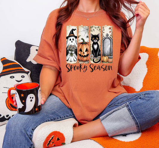 Graphic T-Shirt With Spooky Season Text And Pictures Of Ghost, Black Cat, Tombstone and Jack O Lantern
